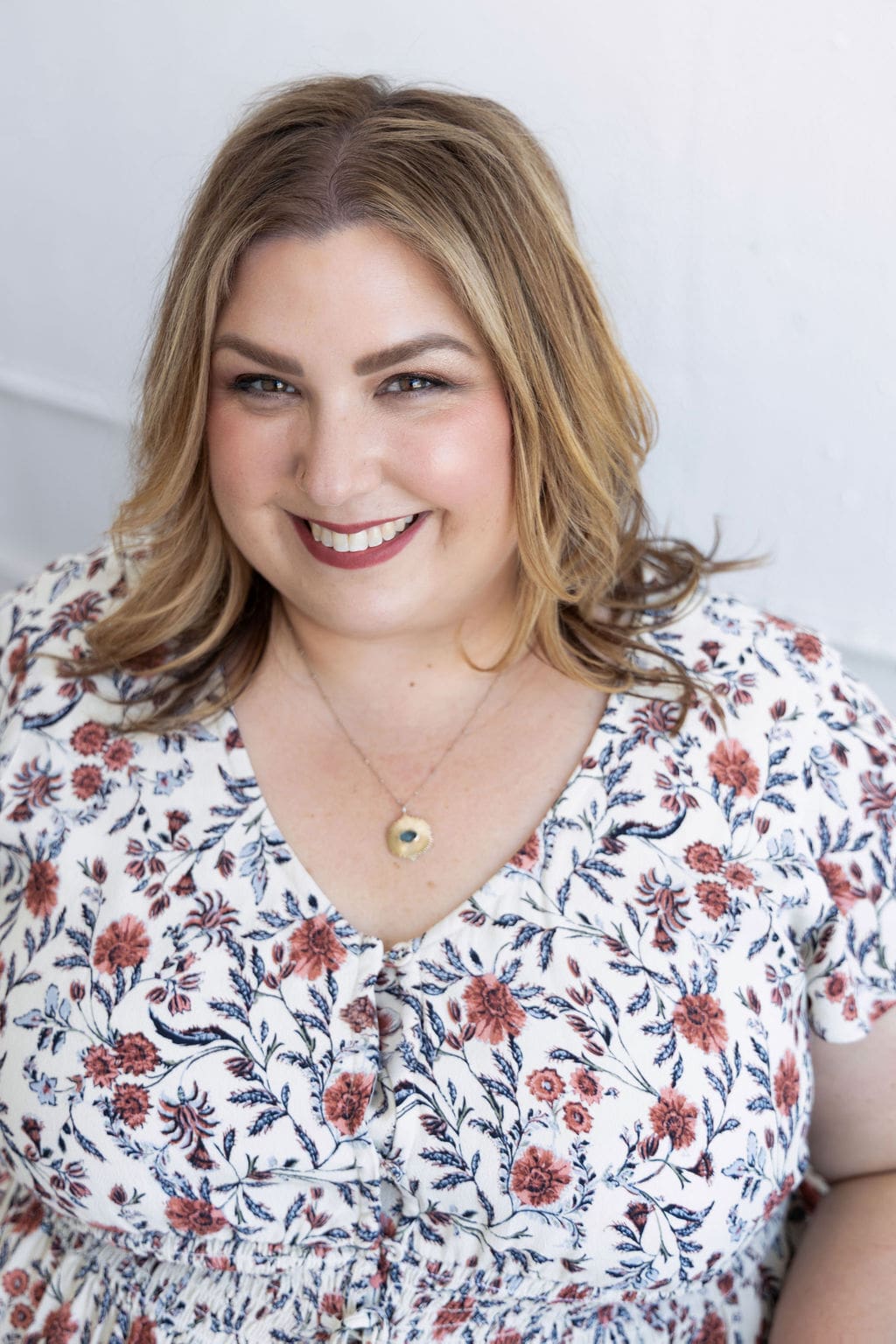 Therapist mentor sitting on a couch and smiling at the camera
