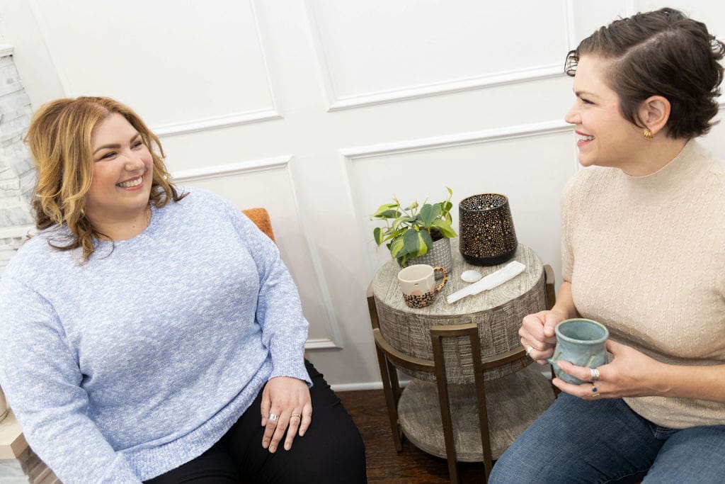 The Empowered Therapist sitting and talking to a somatic experiencing practitioner, discussing trauma and conflict resolution.